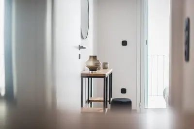 a table with a vase on it in a room at Petraki Residence 1bdr Apt with balcony 1 min from Ermou str in Athens