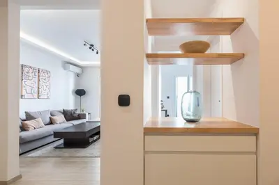 a living room with a couch and a glass vase at Petraki Residence 1bdr Apt with balcony 1 min from Ermou str in Athens