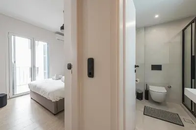 a white bathroom with a bed and a toilet at Petraki Residence 1bdr Apt with balcony 1 min from Ermou str in Athens