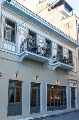 a white building with windows and a balcony at Philia Boutique Hotel in Athens