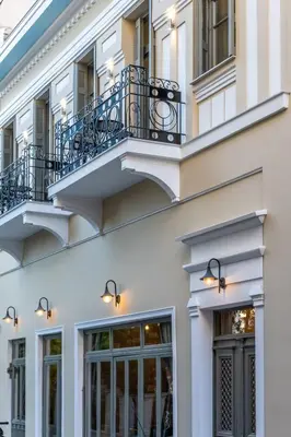 a white building with two balconies on it at Philia Boutique Hotel in Athens