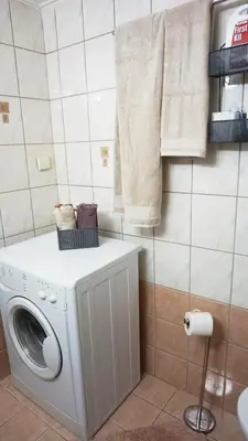 a laundry room with a washing machine and towels at A few steps away from Syntagma and Plaka by Athenian Homes in Athens