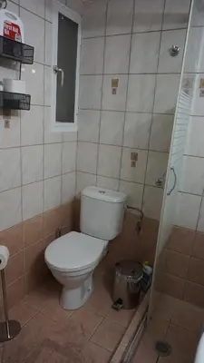 a small bathroom with a toilet and a shower at A few steps away from Syntagma and Plaka by Athenian Homes in Athens
