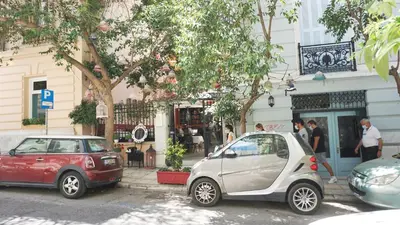 two cars parked in front of a building at A few steps away from Syntagma and Plaka by Athenian Homes in Athens