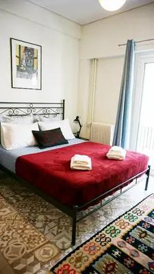 a bedroom with a bed with two towels on it at A few steps away from Syntagma and Plaka by Athenian Homes in Athens
