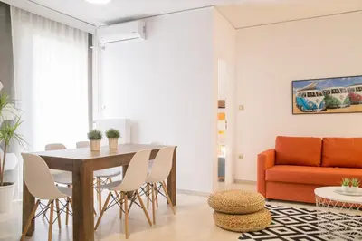 a living room with a table and chairs and a couch at Cozy Apartment in Central Athens - Sleeps 5 in Athens