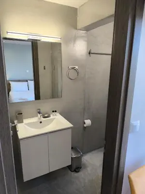 a bathroom with a white sink and a mirror at Peania Domus in Paianía