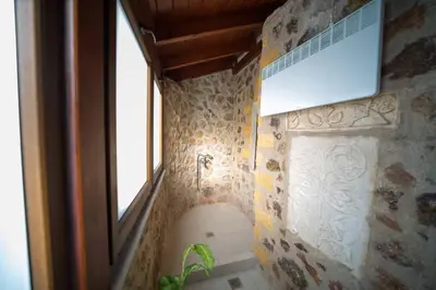 a bathroom with a sink and a window at Stone Villa Lagonisi in Lagonissi