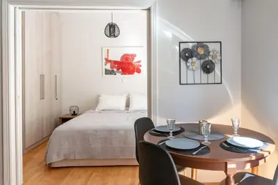 a bedroom with a bed and a table with chairs at Plaka Central in Athens
