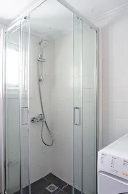 a shower with a glass door in a bathroom at Plaka Central in Athens