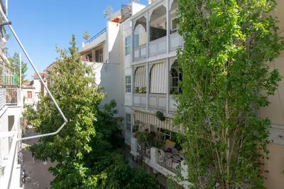 an apartment building with trees in front of it at Plaka Central in Athens