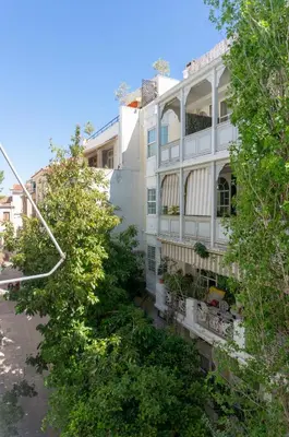 a white building with trees in front of it at Plaka Central in Athens
