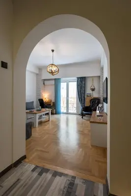 an open living room with an archway and a living room at Blue Ark Loving Athens in Athens