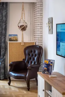 a brown leather chair in a room with a desk at Blue Ark Loving Athens in Athens