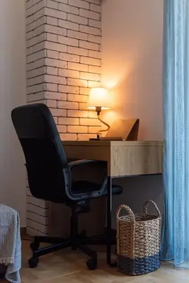 a black chair sitting at a desk with a lamp at Blue Ark Loving Athens in Athens