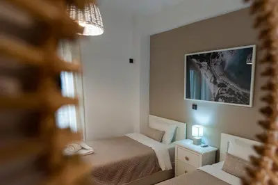 a small bedroom with two beds and a mirror at Blue Ark Loving Athens in Athens