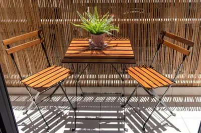 a table with two chairs and a potted plant on it at Blue Ark Loving Athens in Athens