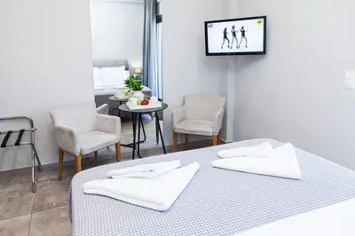 a bedroom with two beds and a table and chairs at D Spacious Brand New Studio Ideal for 2 D in Athens