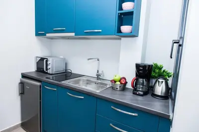 a kitchen with blue cabinets and a sink at D Spacious Brand New Studio Ideal for 2 D in Athens