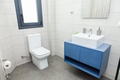 a bathroom with a white toilet and a sink at D Spacious Brand New Studio Ideal for 2 D in Athens