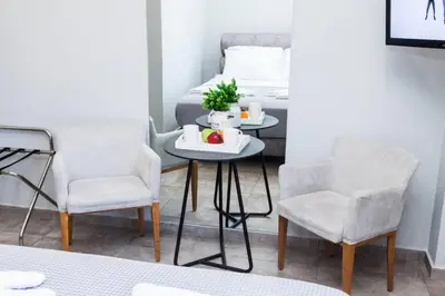 a table and two chairs in a room with a bed at D Spacious Brand New Studio Ideal for 2 D in Athens