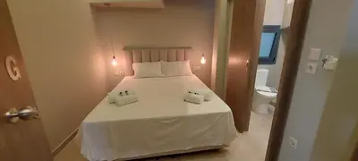a bedroom with a white bed with two towels on it at D Spacious Brand New Studio Ideal for 2 D in Athens