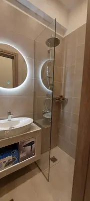a bathroom with a glass shower and a sink at Apartments Vouliagmenis Ave 126 in Athens