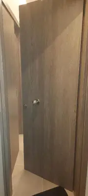 a shower with a wooden door in a bathroom at Apartments Vouliagmenis Ave 126 in Athens