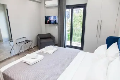 a bedroom with a large bed with two towels on it at Apartments Vouliagmenis Ave 126 in Athens