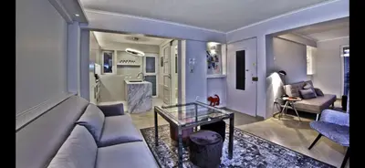 a living room with a couch and a glass table at kolonaki Penthouse panoramic Acropolis view in Athens