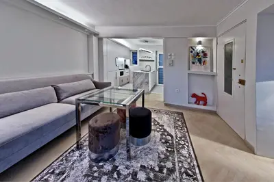 a living room with a couch and a glass table at kolonaki Penthouse panoramic Acropolis view in Athens