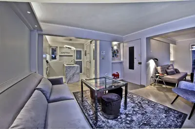 a living room with a couch and a glass table at kolonaki Penthouse panoramic Acropolis view in Athens