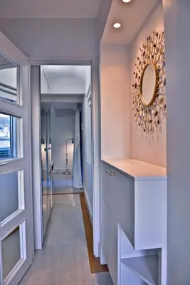 a bathroom with a mirror on the wall next to a door at kolonaki Penthouse panoramic Acropolis view in Athens