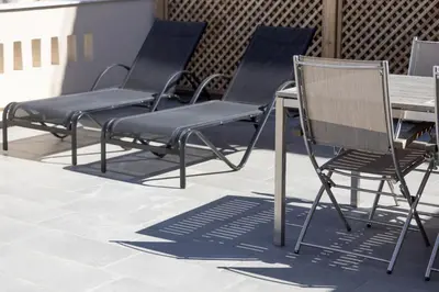 a group of chairs and a table on a patio at Downtown Cocoon with Roof Deck in Athens
