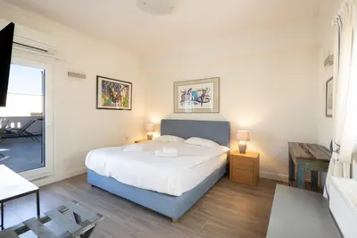 a bedroom with a large bed and a table at Downtown Cocoon with Roof Deck in Athens