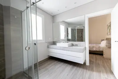 a bathroom with a sink and a glass shower at Historic Plaka's Deluxe Apartment in Athens