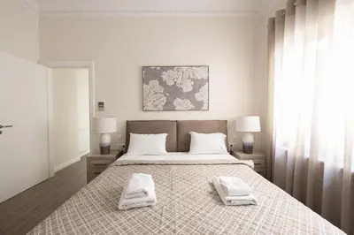 a bedroom with a bed with two towels on it at Historic Plaka's Deluxe Apartment in Athens