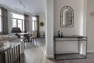 a living room with a table and a mirror at Historic Plaka's Deluxe Apartment in Athens