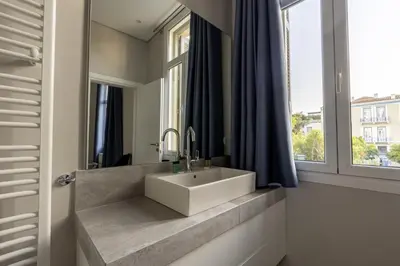a bathroom with a sink and a window at Historic Plaka's Deluxe Apartment in Athens