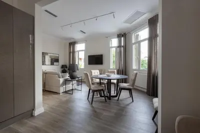 a living room with a table and chairs at Historic Plaka's Deluxe Apartment in Athens