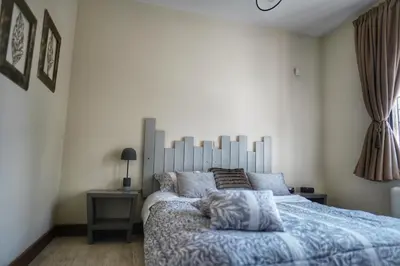 a bedroom with a large bed with a blue comforter at Villa Evinoi in Pallíni