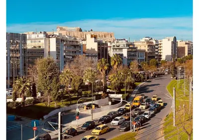 a busy city street filled with parked cars and buildings at Cozy Apartment in Central Athens - Sleeps 6 in Athens
