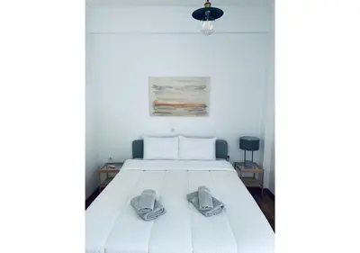 a bedroom with a bed with two slippers on it at Cozy Apartment in Central Athens - Sleeps 6 in Athens