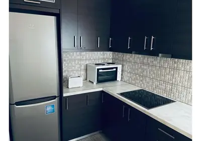 a kitchen with black cabinets and a microwave oven at Cozy Apartment in Central Athens - Sleeps 6 in Athens