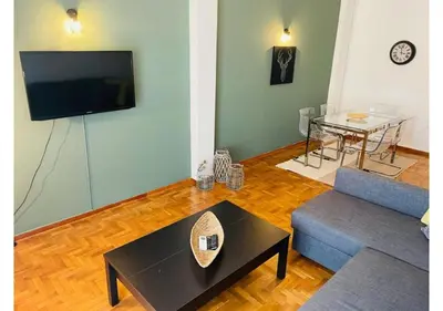 a living room with a couch and a table at Cozy Apartment in Central Athens - Sleeps 6 in Athens