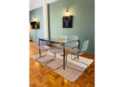 a glass dining table and chairs in a room at Cozy Apartment in Central Athens - Sleeps 6 in Athens