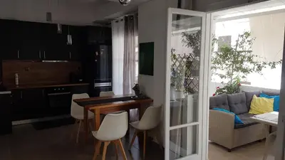 a kitchen and living room with a table and chairs at Dream apartment in Athens