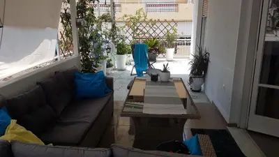 a living room with a couch and a table at Dream apartment in Athens