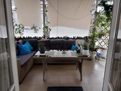 a living room with a couch and some plants at Dream apartment in Athens