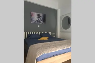 a bedroom with a bed with blue and yellow pillows at Dream apartment in Athens